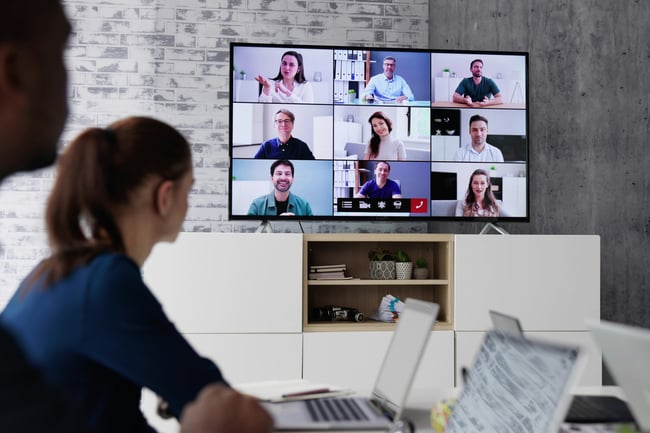 Woman on a video call with employees in different locations. 