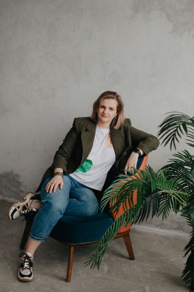 a-young-pretty-woman-in-a-casual-jacket-sits-on-a-2024-10-18-04-23-53-utc