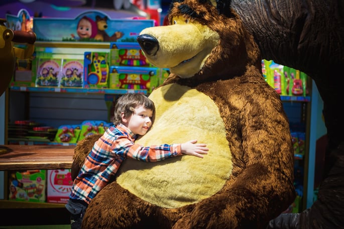 child hugging a teddy bear