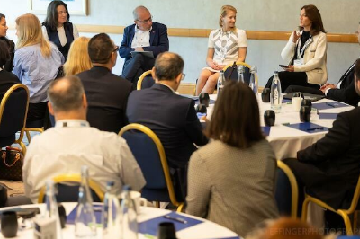 A conceptual illustration showing two hands reaching towards each other Between them a bridge is forming made of glowing digital data streams stylized-1