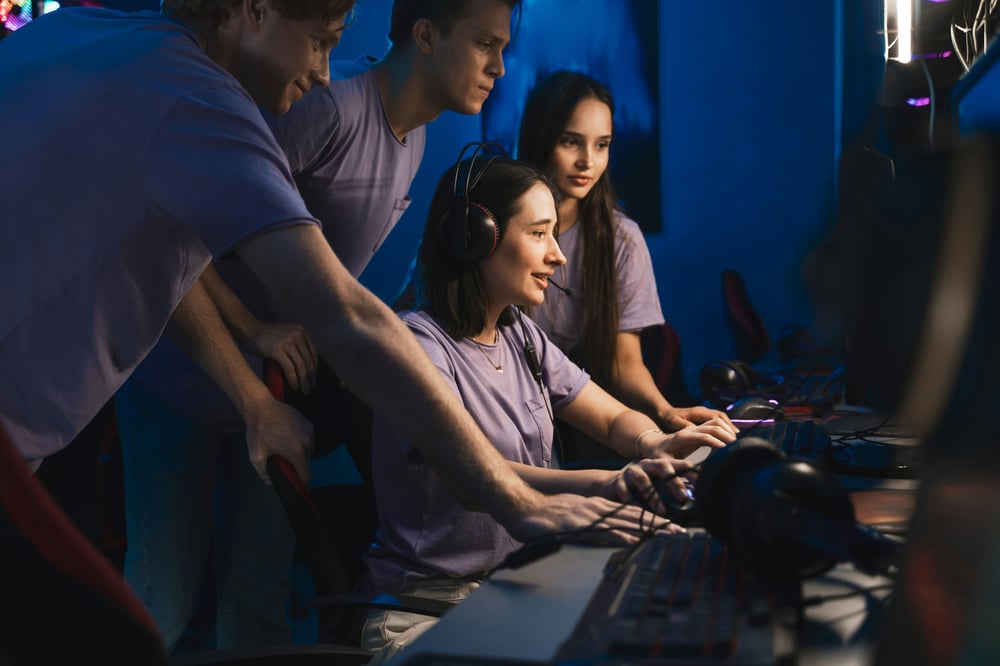 Team of staff augmented developers working on a computer together.  