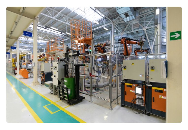 Manufacturing plant floor with machines in the background Manufacturing plant floor with machines in the background