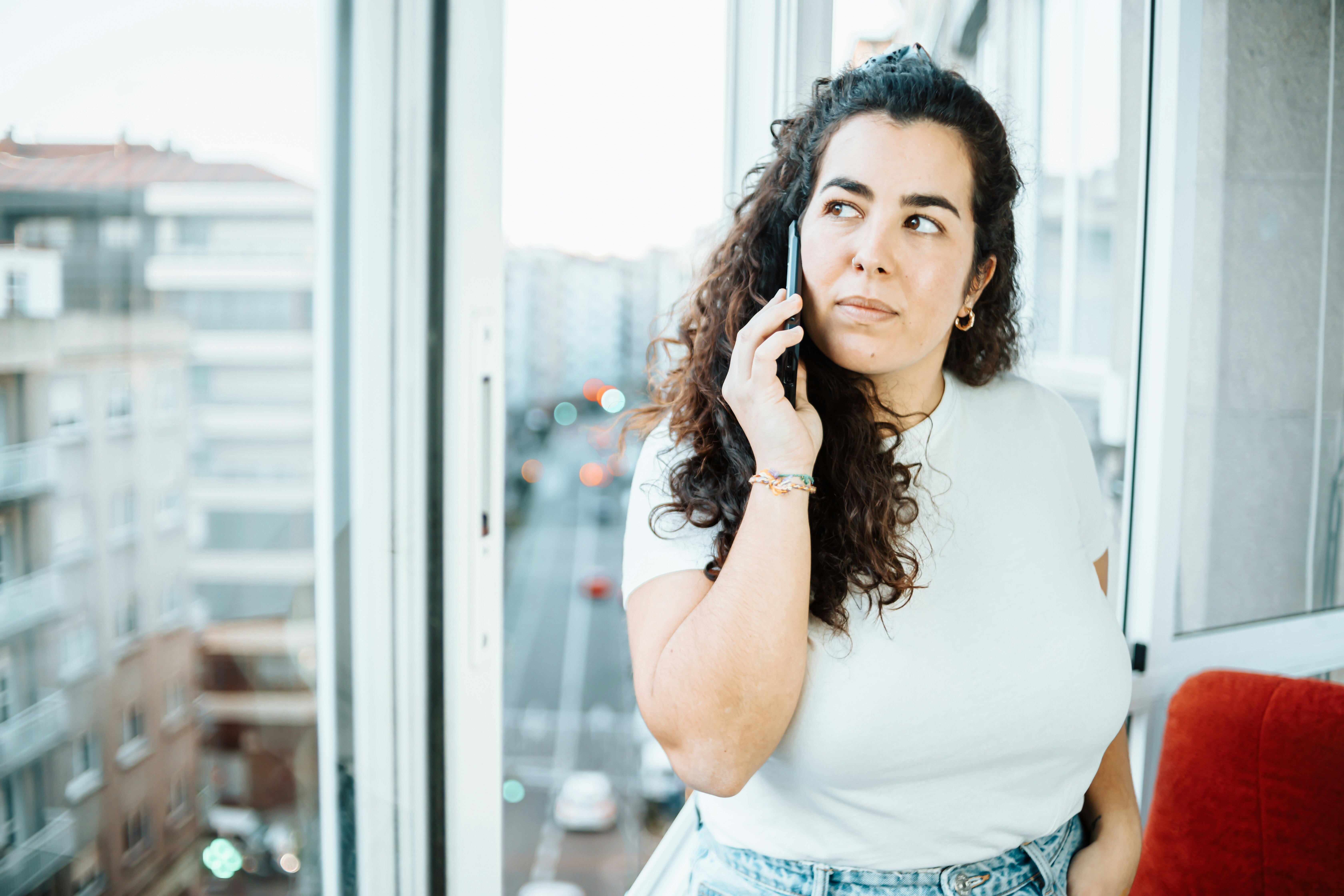 Woman on phone waiting on hold. Woman on phone waiting on hold.