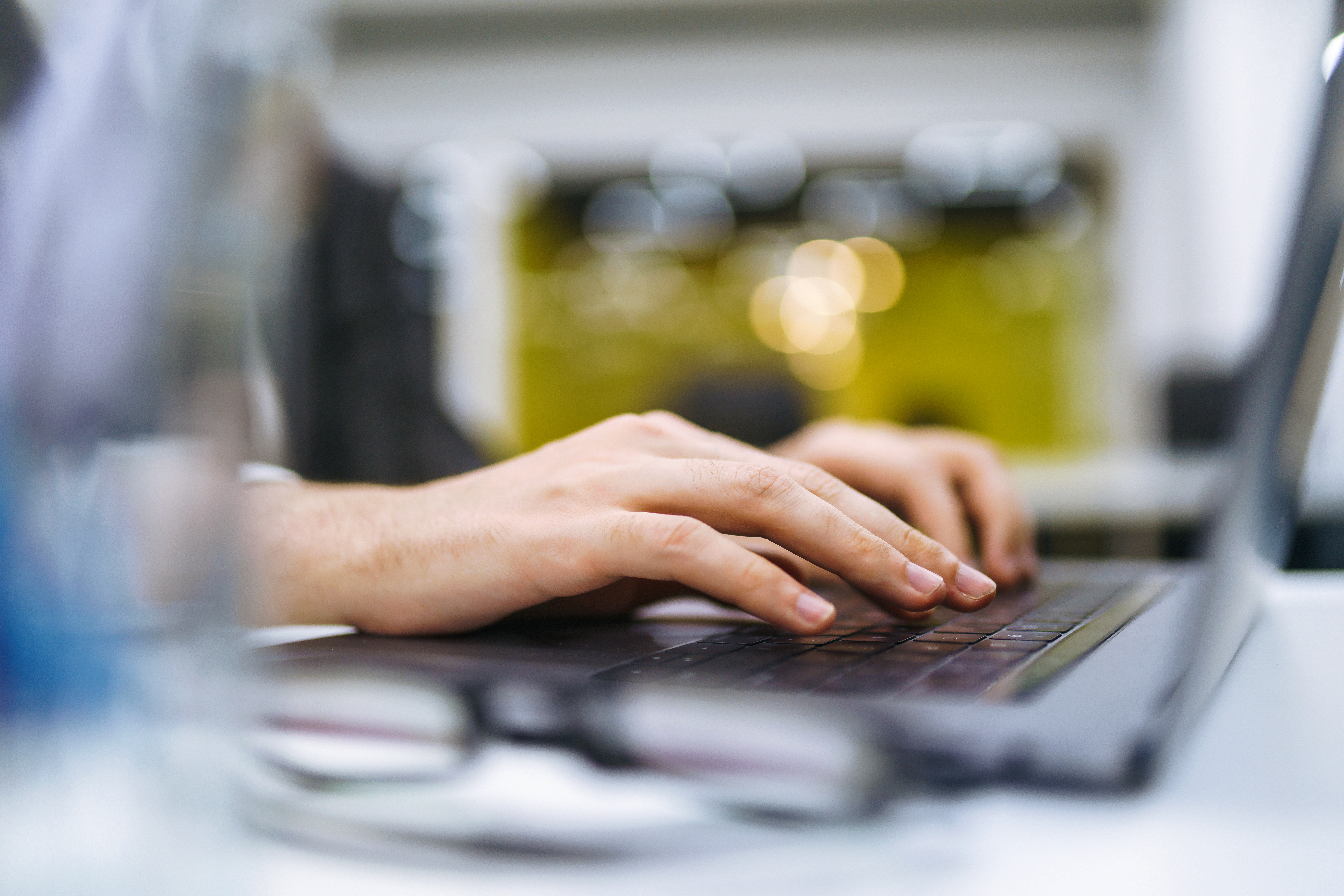 Person typing on a computer keyboard