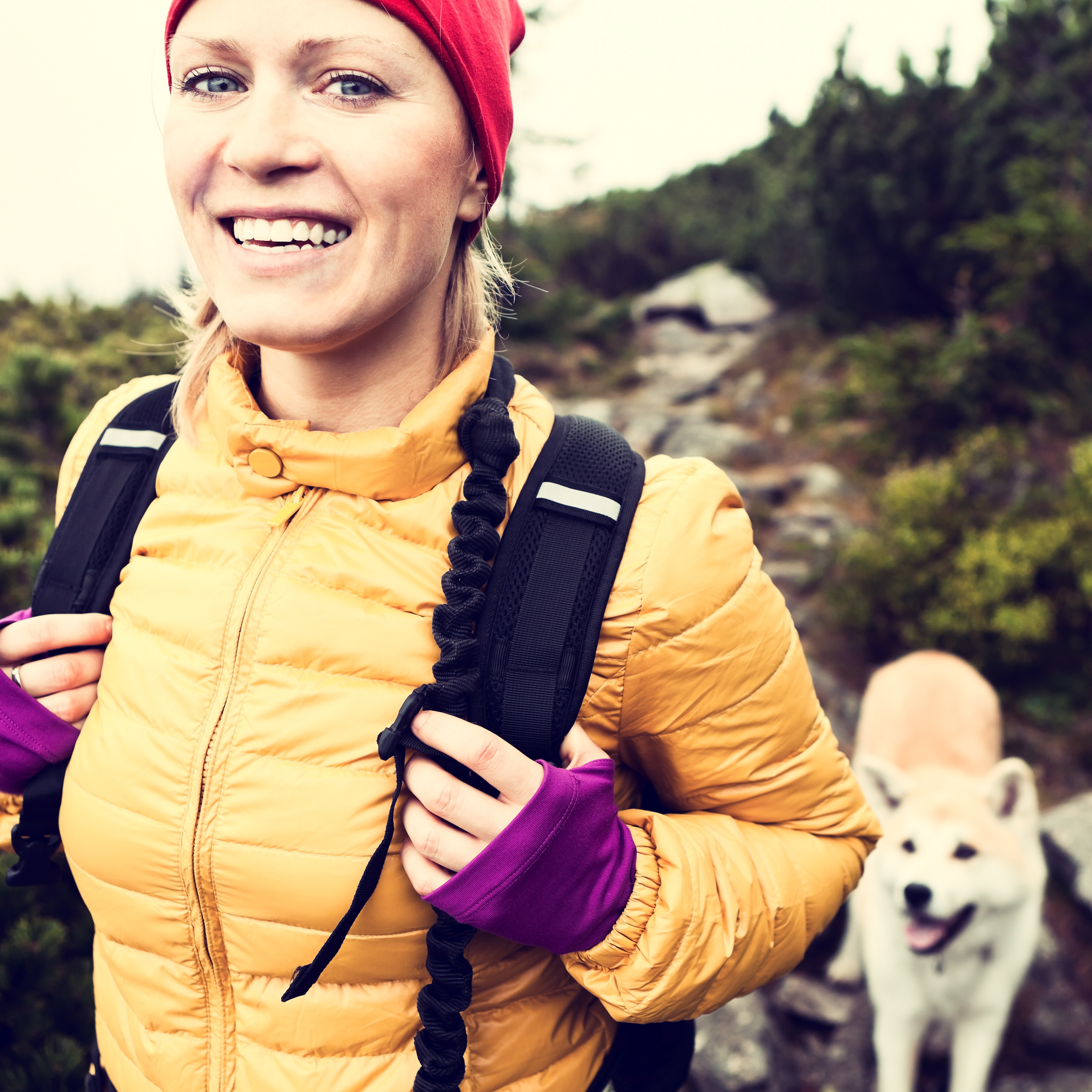 happy-woman-hiking-in-vintage-mountains-with-dog-2024-09-11-09-29-18-utc